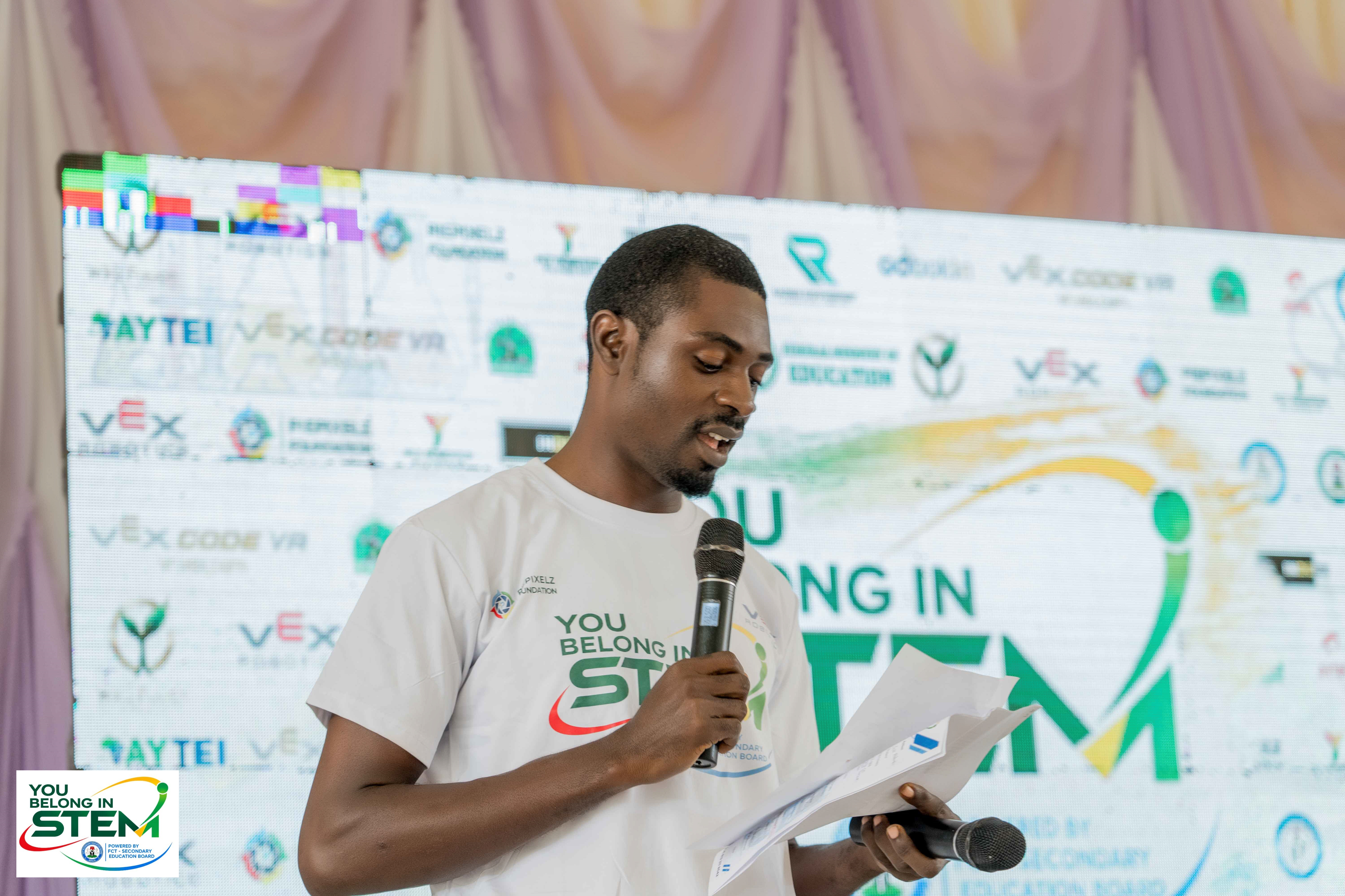 Mr. Akeem, Master of Ceremony, handling the You Belong in STEM FCT Edition event